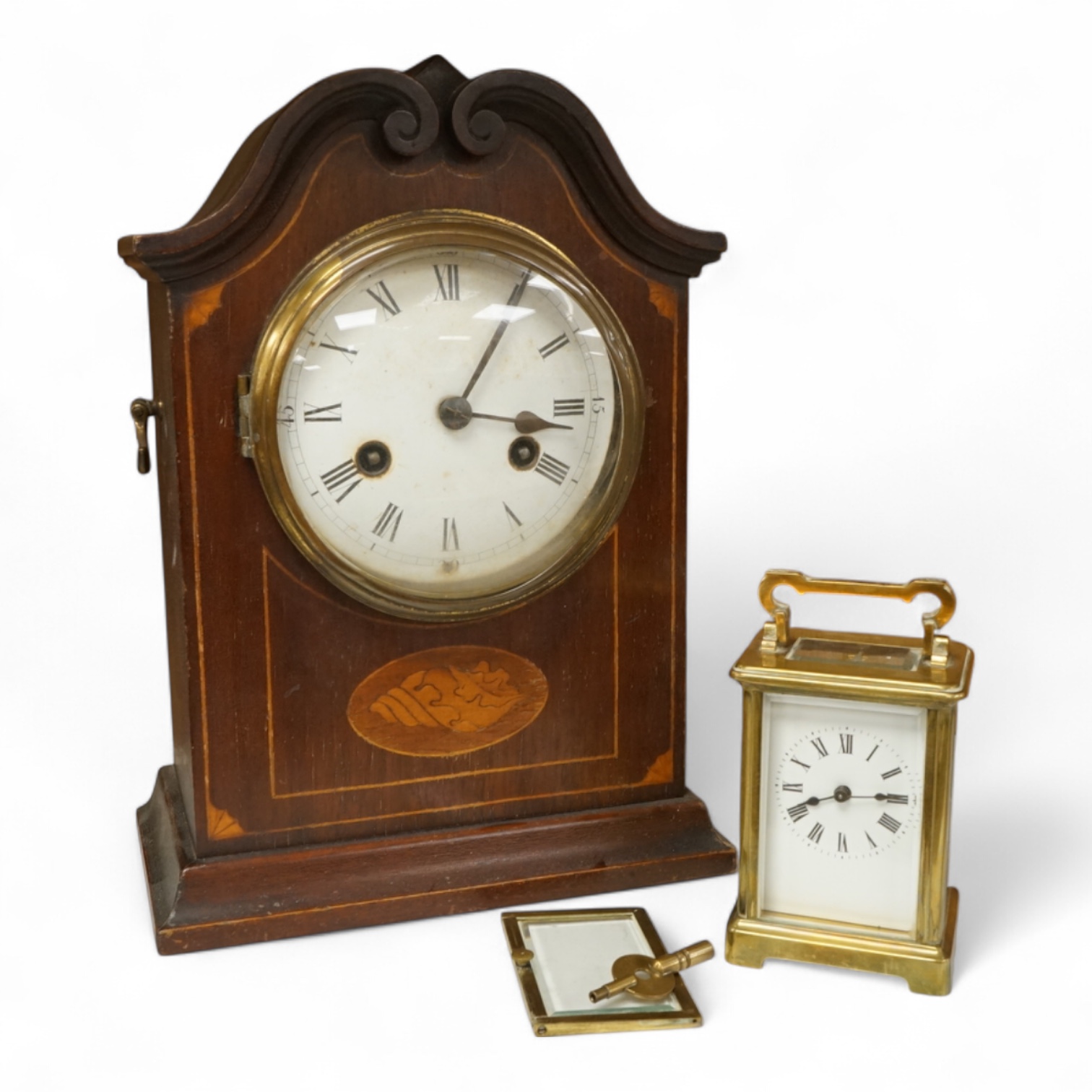 An early 20th century inlaid mantel clock with key and pendulum and a brass cased carriage timepiece, largest 32cm high